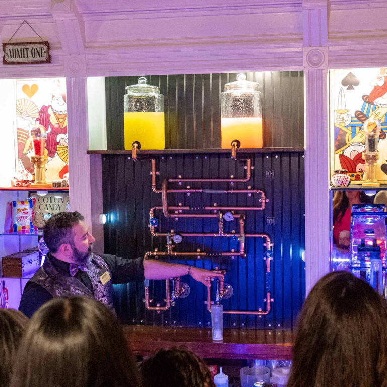 Magic Saloon guests watching barman